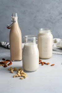 two jars of almond milk and a jar of almonds