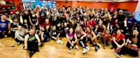 a group of people posing for a photo in a gym